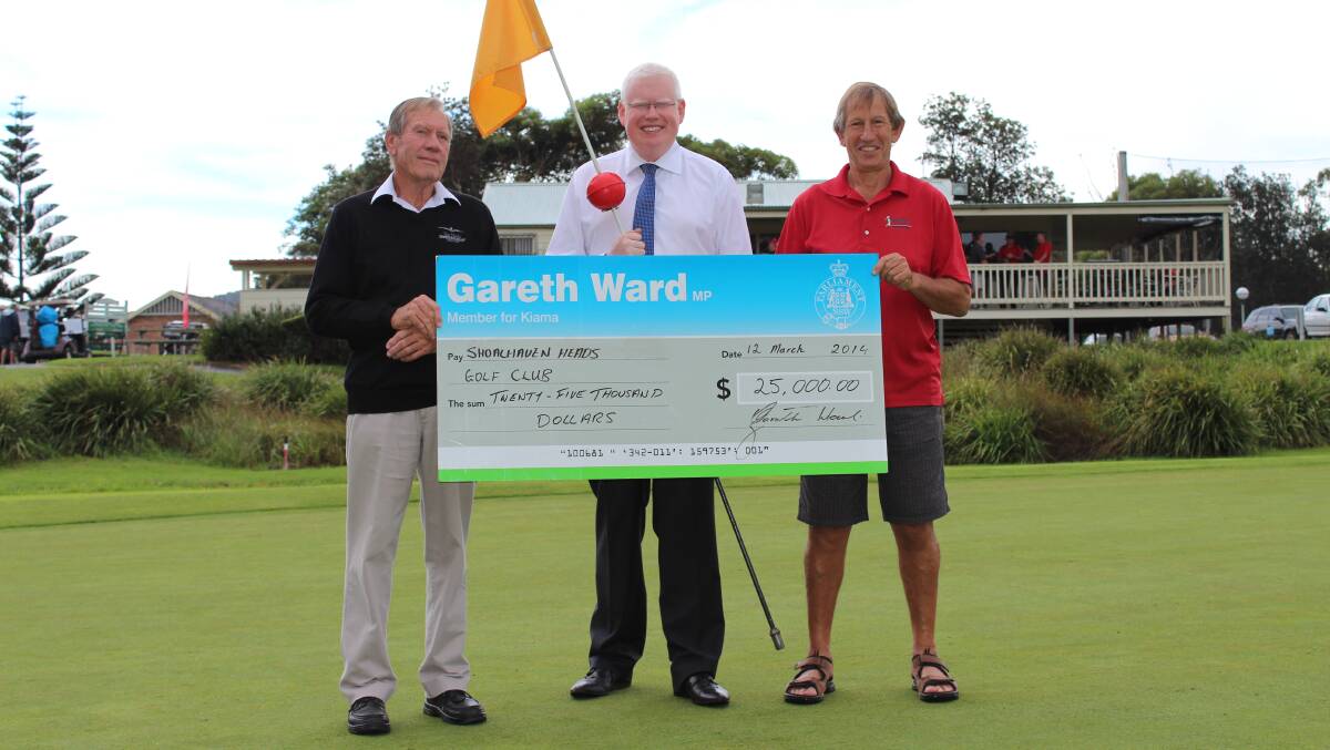 GIFT OF GOLF: Shoalhaven Heads Golf Club secretary David Lamb is delighted to receive funding from the NSW government, presented by member for Kiama Gareth Ward, with Shoalhaven Heads Golf Club vice president Rob Russell.