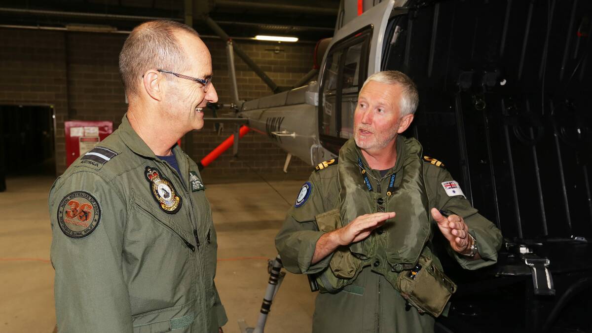 TOUCHDOWN: RAAF Air Commander Air Vice-Marshal Melvin Hupfeld speaks with Lieutenant Cliff Gaudie before taking a flight in a Squirrel helicopter at HMAS Albatross. Photo: JESSE RHYNARD