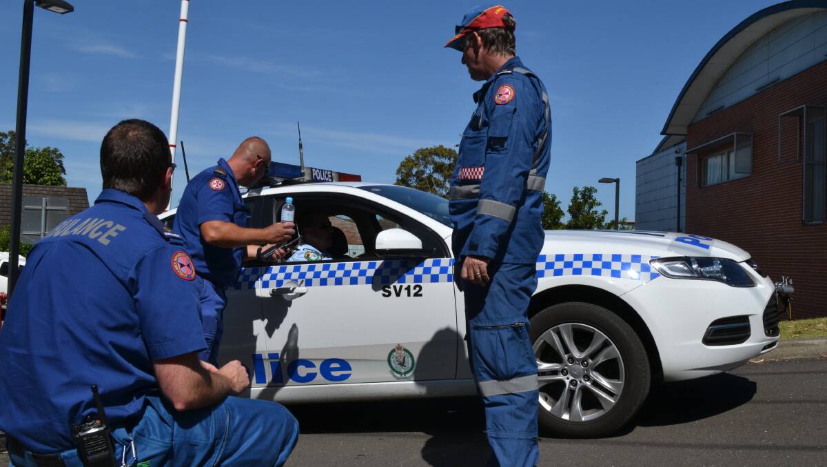 DRUG DRAMA: Police talk to ambulance paramedics outside Shoalhaven District Hospital after a patient, believed to be on ice, became aggressive on Thursday afternoon.
