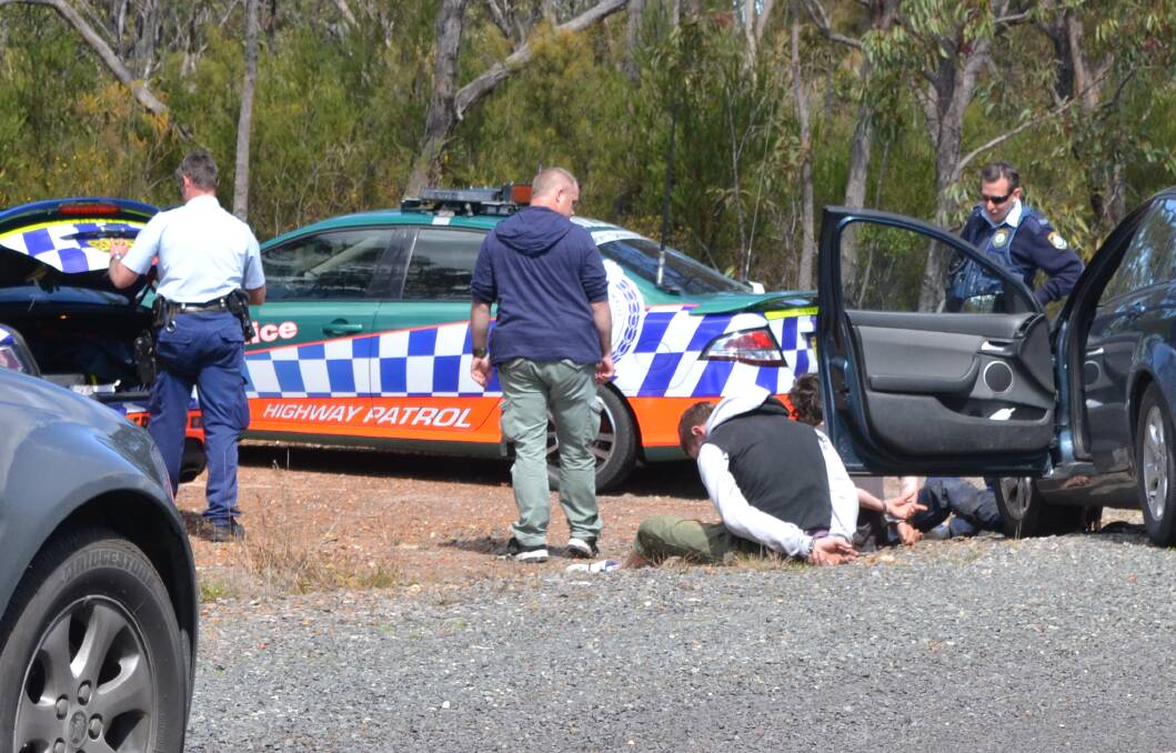 GAME OVER: Police with the three males caught after a high-speed pursuit on Thursday.
