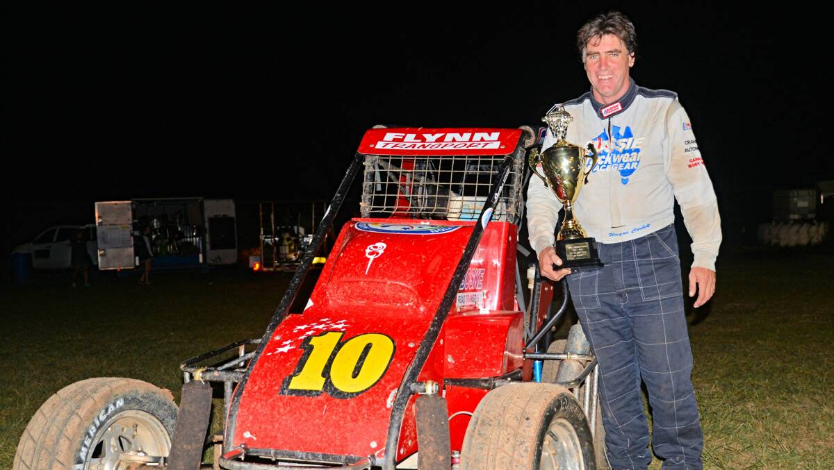 WINNERS ARE GRINNERS: Wayne Corbett displays his trophy after taking out the NSW Title for compact speedcars. Photo: MAXIMUM ACTION PHOTOGRAPHY