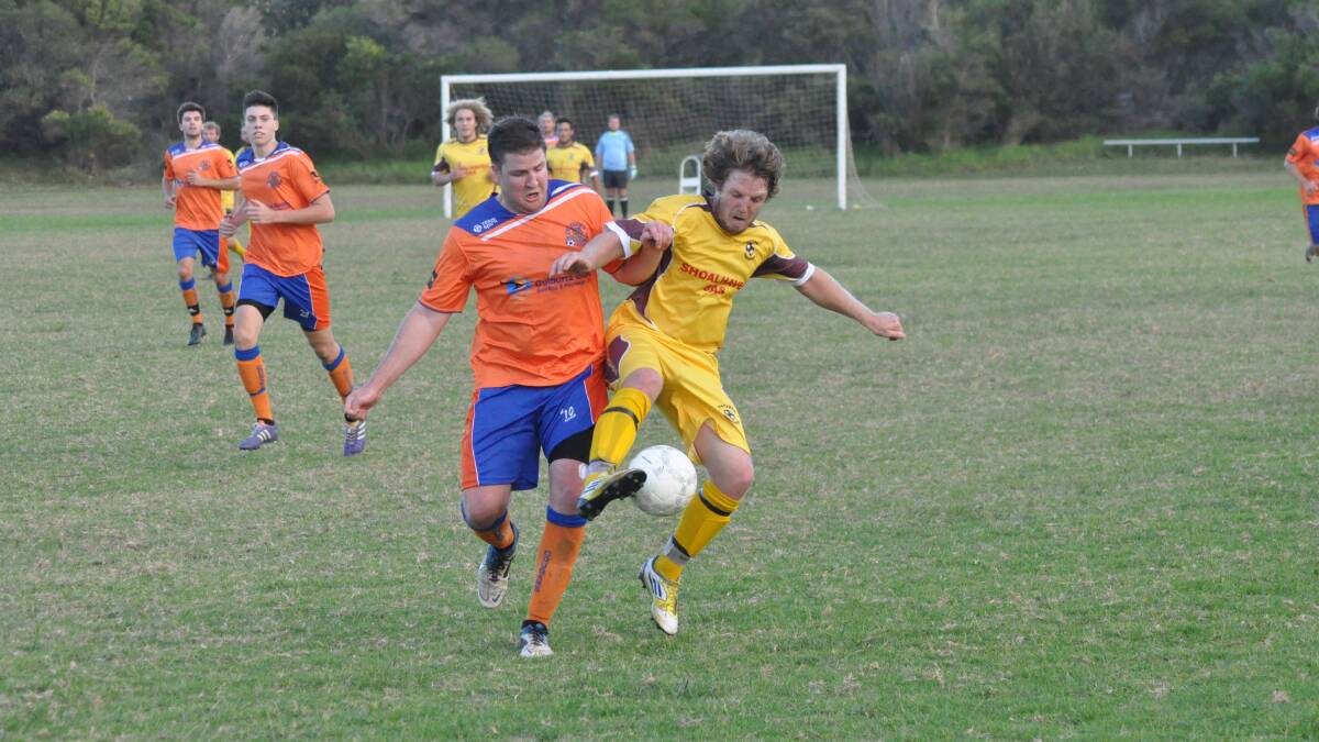 COUGARS ON TOP: Culburra Cougars’ Jack Miller clashes with Manyana Wanderers’ Ben Daley in last week’s clash when the Cougars won 4-nil. Photo: PATRICK FAHY