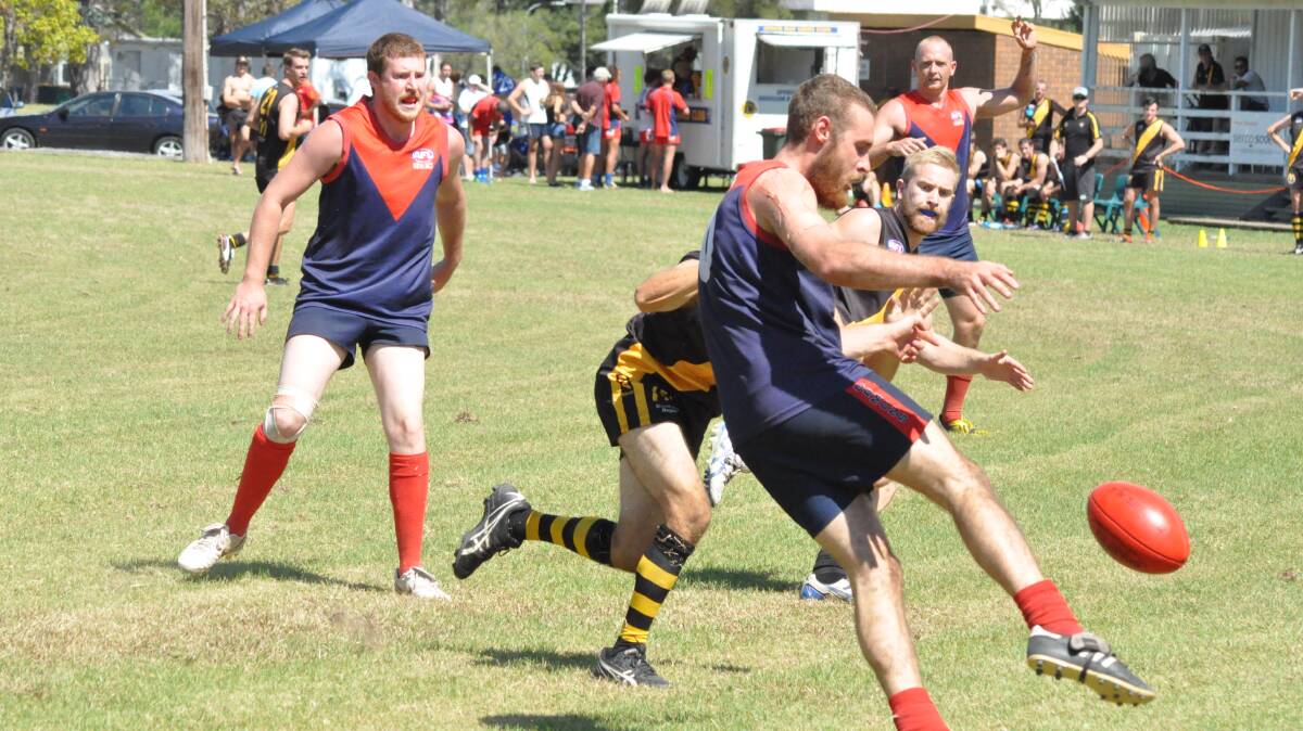 CLEARANCE: Demons captain Jake Leske tries to get rid of the ball as the Bomaderry Tigers’ defenders close in.