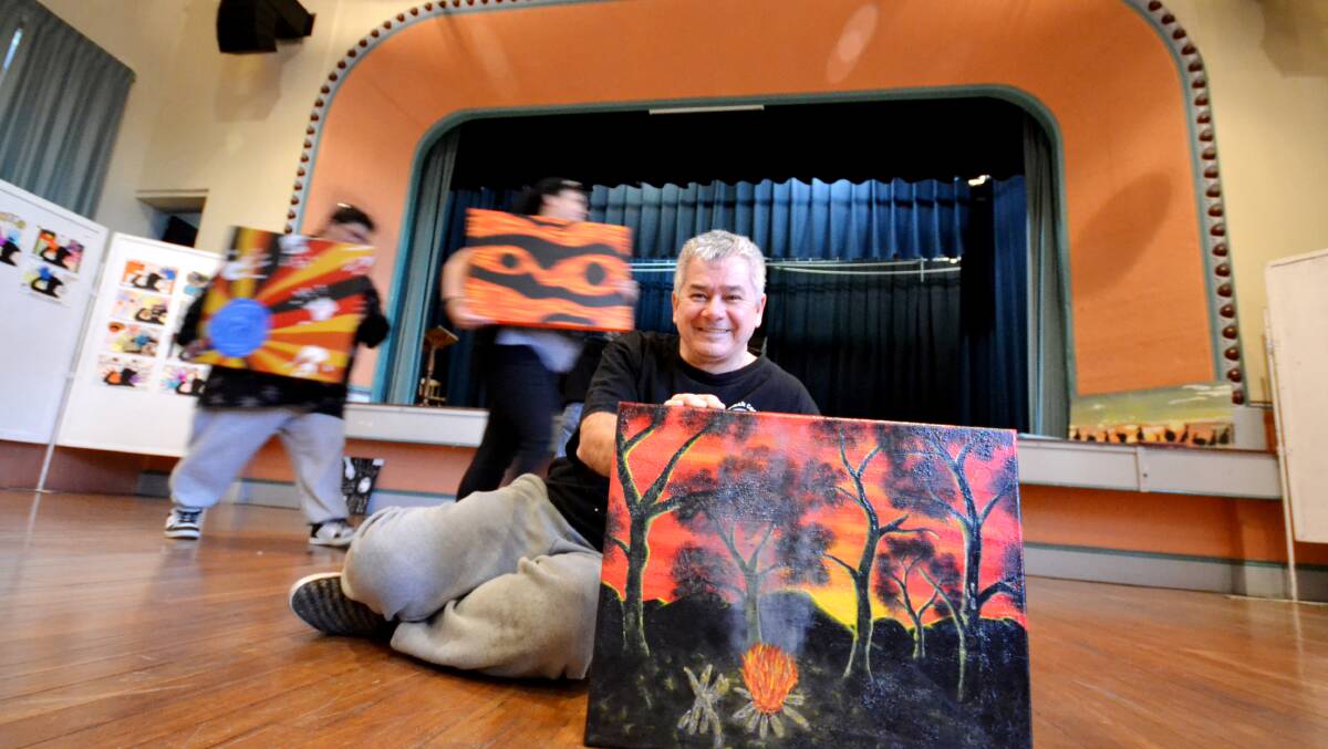 BLACK COCKATOO COLLECTION: Wayne Graham from Nowra with his painting titled Campfire will be among the large selection of Aboriginal artists’ works on display in the Nowra School of Arts this week. Photo ADAM WRIGHT