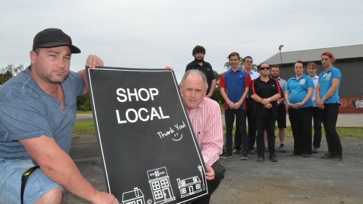 BATTLE LINE: Brendon Lord and Wes Hindmarsh along with other Bomaderry workers Chris Emery, Brendan Kellett, Joel Lord, Rosa Sharman, Adam Pritchett, Stacey Alexander, Debbie Simpson and Sarah Newton fear they may lose jobs if a new Woolworths is built on the former John Bull site. 