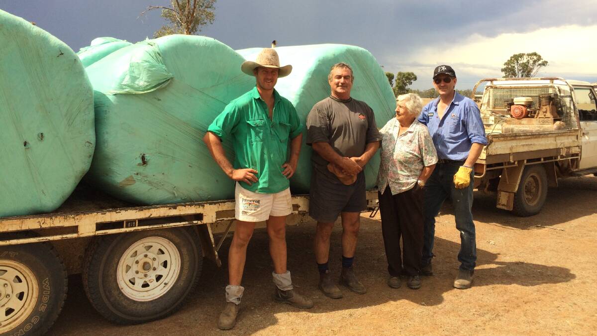 HOPE ARRIVES: Josh Borowski, Basil, his mum Hazel from Coonamble with Dave Bennett from Nowra load up their share of the stock feed delivered from the Shoalhaven on the weekend.