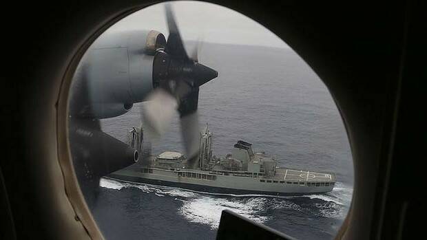 A Royal Australian Air Force AP-3C Orion flies past HMAS Success as they search for missing Malaysia Airlines flight MH370 in the southern Indian Ocean on March 22, 2014. Photo: AFP/Pool