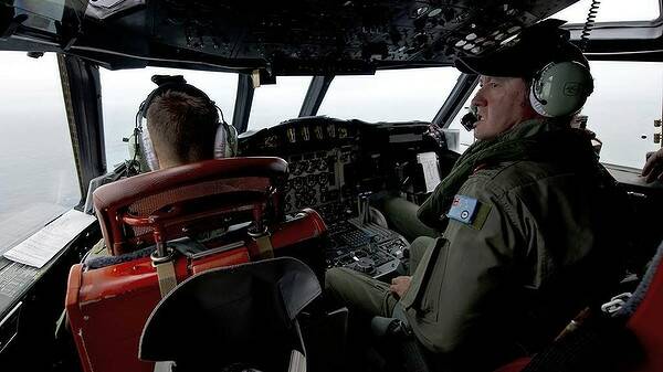 Royal Australian Air Force Flight Engineer, Warrant Officer Ron Day from 10 Squadron, keeps watch for any debris as he flies in an AP-3C Orion over the Southern Indian Ocean during the search for missing Malaysian Airlines flight MH370. Photo: HANDOUT 