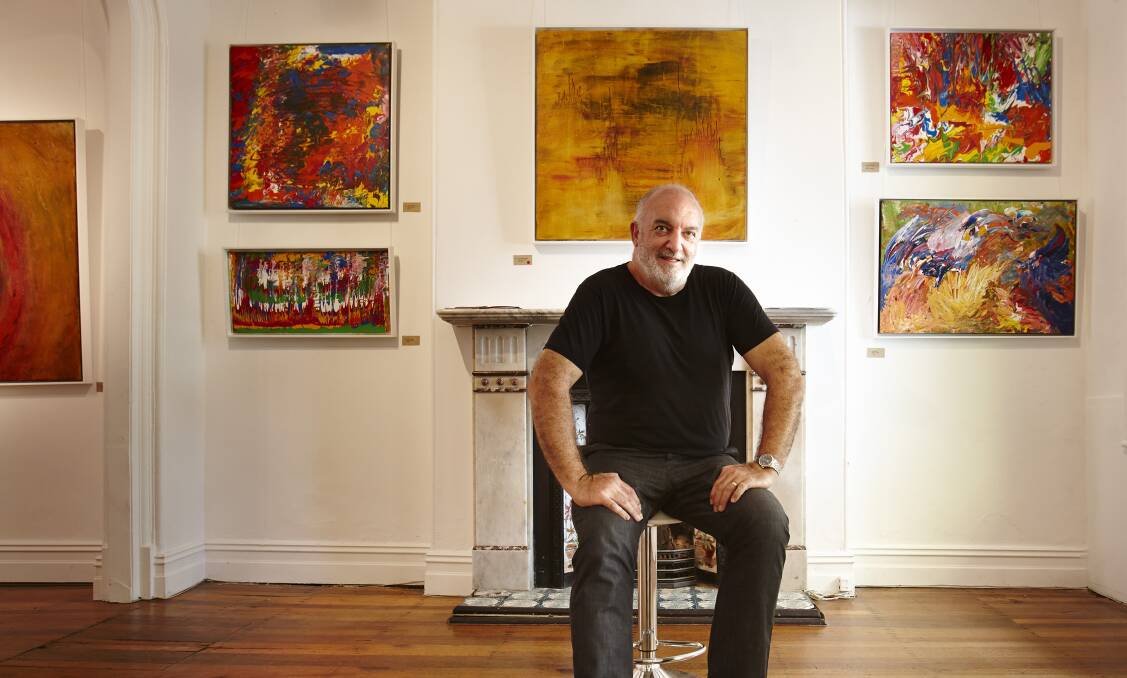 INSPIRING: Self-taught contemporary artist Bernard McGrath from Berry sits among some of his artworks from his latest exhibition, Shaken. 	Photo: JOHN FRYZ