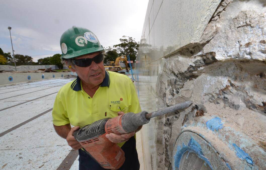 LAST LOOK: Contractor John Brown starts removing the glass from the Nowra Pool lights, before the excavator moves in to demolish the structure.
