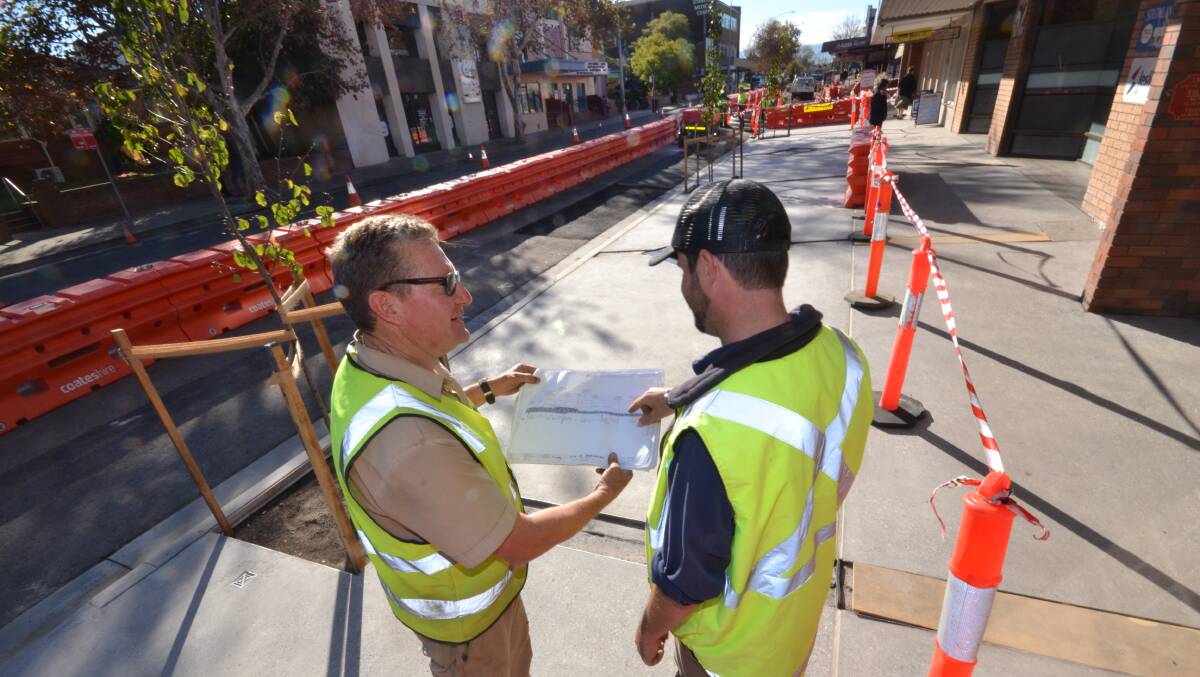 PAVING THE WAY: Shoalhaven City Council construction supervisor Bill Garrick and surveyor Glen Mitchell go over some of the almost complete section of the Berry Street footpath.