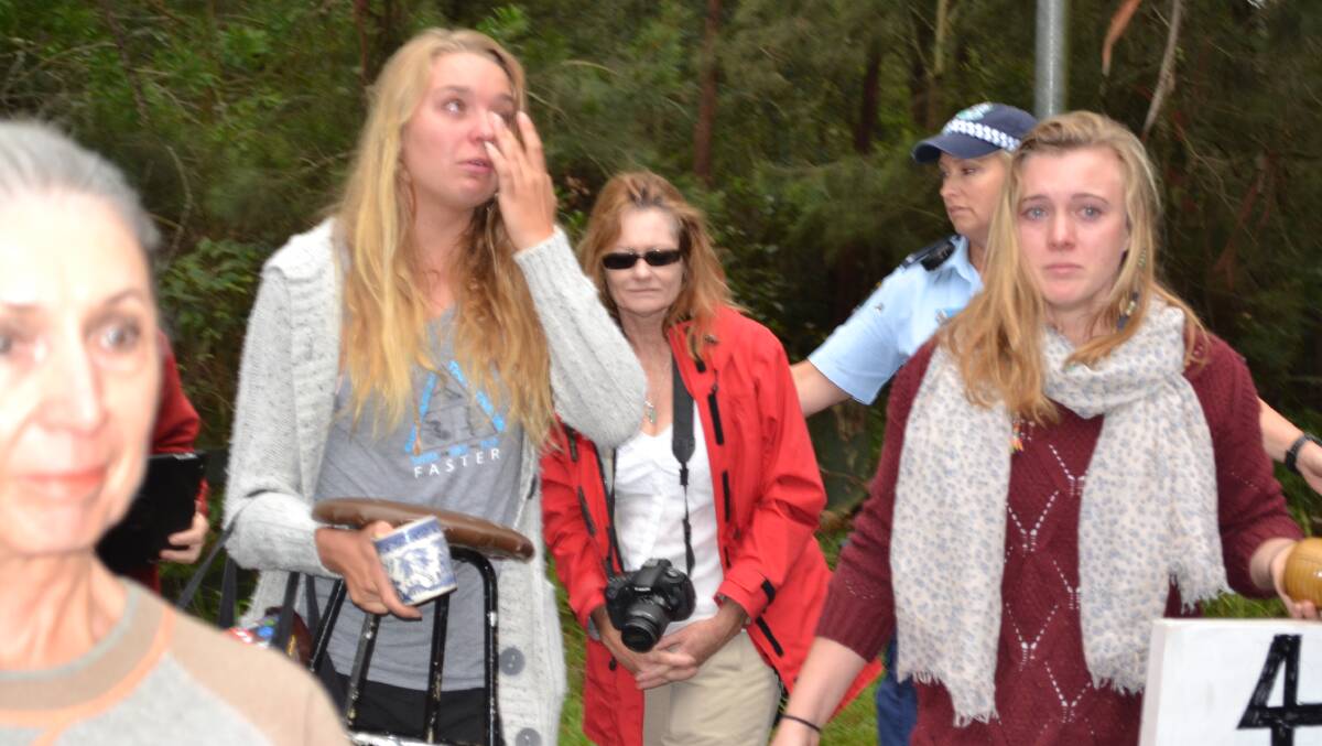 TEARS FOR TREES: Tarni Cunningham, 18, from Gerroa and Meg O’Connor, 18, of Shoalhaven Heads are overcome by emotion after being removed from the Bum Tree, to which they had tied themselves.