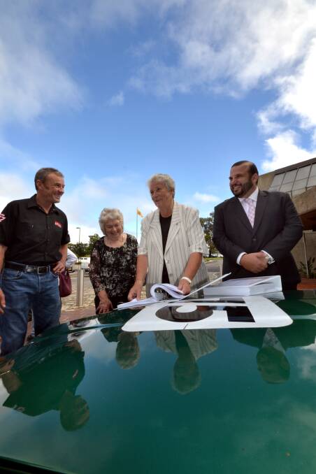 RACING AHEAD: Former world superbike champion Kevin Magee, Motorcycling NSW president Christine Tickner, Shoalhaven Mayor Joanna Gash and Motorcycling NSW general manager Daniel Gatt look through the $400,000 reports that make up part of the racing organisation’s development application to build a $12 million facility at Yerriyong.