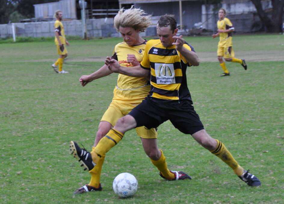 CLASH OF GOLD: Manyana’s Sam Swan and Bomaderry’s Daniel Frew fight for possession.  	Photo: GILLIAN LETT