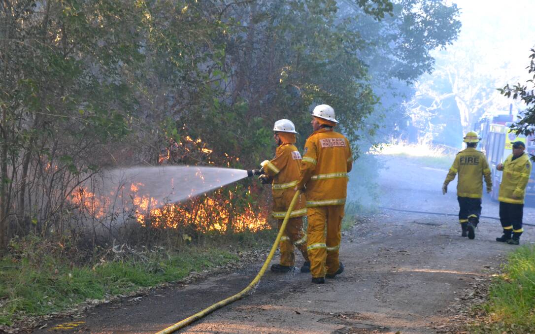 ON GUARD: Firefighters battle a blaze believed to have been deliberately lit in Bomaderry last week. Arsonists face stiffer penalties.   
