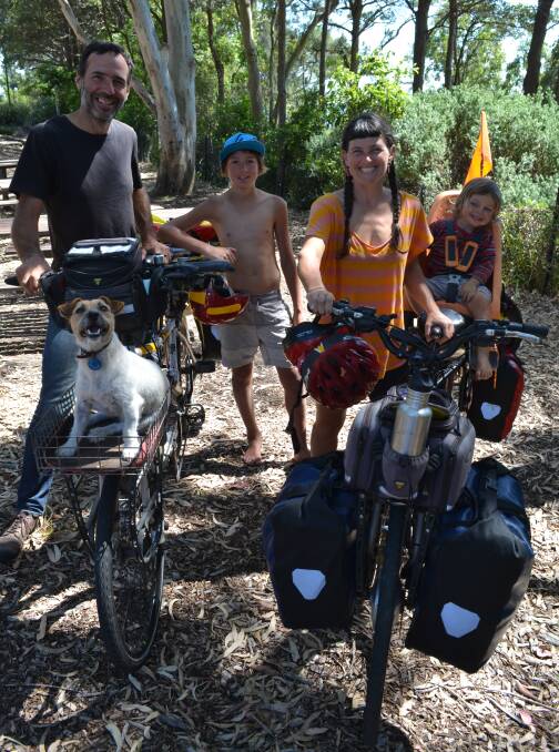 FAR TREK: Patrick Jones and Meg Ulman with their two sons Zephyr (12) and Woody (2) with their pet dog and chief rabbit catcher Zero have spent a year riding their bicycles across Australia and have stopped for a rest in Huskisson before riding back to their home in Victoria.