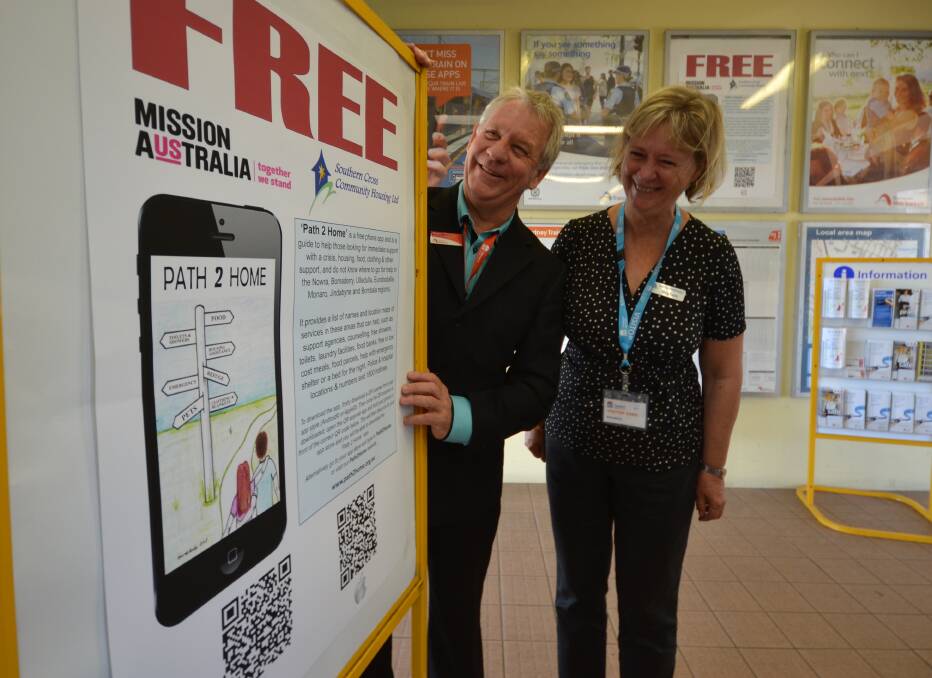 HELP AT HAND: Transport NSW Train Link customer service spokesman Wayne Simpson and Southern Cross Community Housing CEO Marg Kaszo were proud to put a Path2Home poster in the train station at Bomaderry.