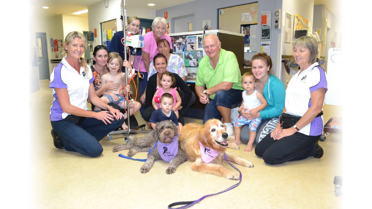 PUPPY LOVE: Nowra man Kevin Cummins has backed the Paws Pet Therapy group to make visits to the Shoalhaven Hospital children’s ward. Staff members Emma Morgans, Michelle Piper, Andrea McAuliffe with Dom Wilkinson and Corey (5), Mary Jones with Elijah (5) and Olivia (3), Michelle Chase with Tyrell Hutchison (1) with Paws Pet Therapy volunteers Samantha Egan with Coco and Dawn Spicer with Bear during their first visit on Tuesday.