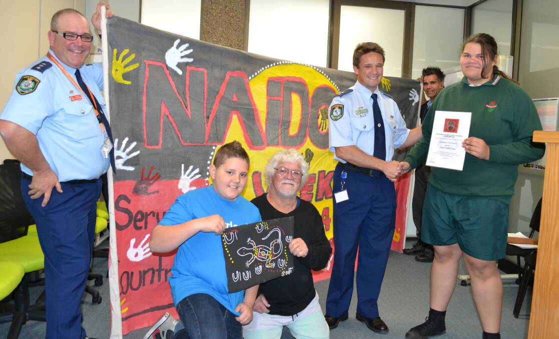 WINNERS: Shoalhaven Local Area Commander Superintendent Joe Cassar and Aboriginal elder Uncle Laddie Timbery present prizes to the winners of the inaugural Commander’s Aboriginal Artwork Competition Olivia Atkins and Cooper Glover, with Aboriginal issues officer Inspector Steve Johnson (left) and Shoalhaven Aboriginal community liaison officer Ben Wellington.