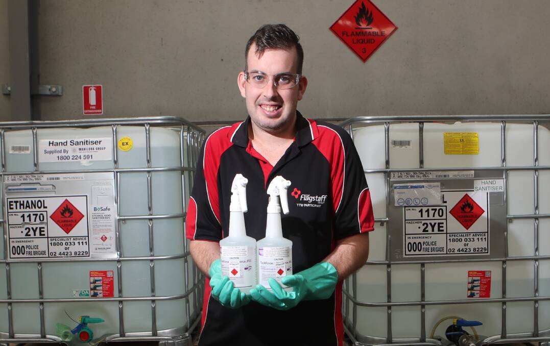 Bulk hand sanitiser: Lochie Harley's job at the Flagstaff Group is filling bottles with hand sanitiser made locally by Manildra Group at Bomaderry. Picture: Sylvia Liber. 