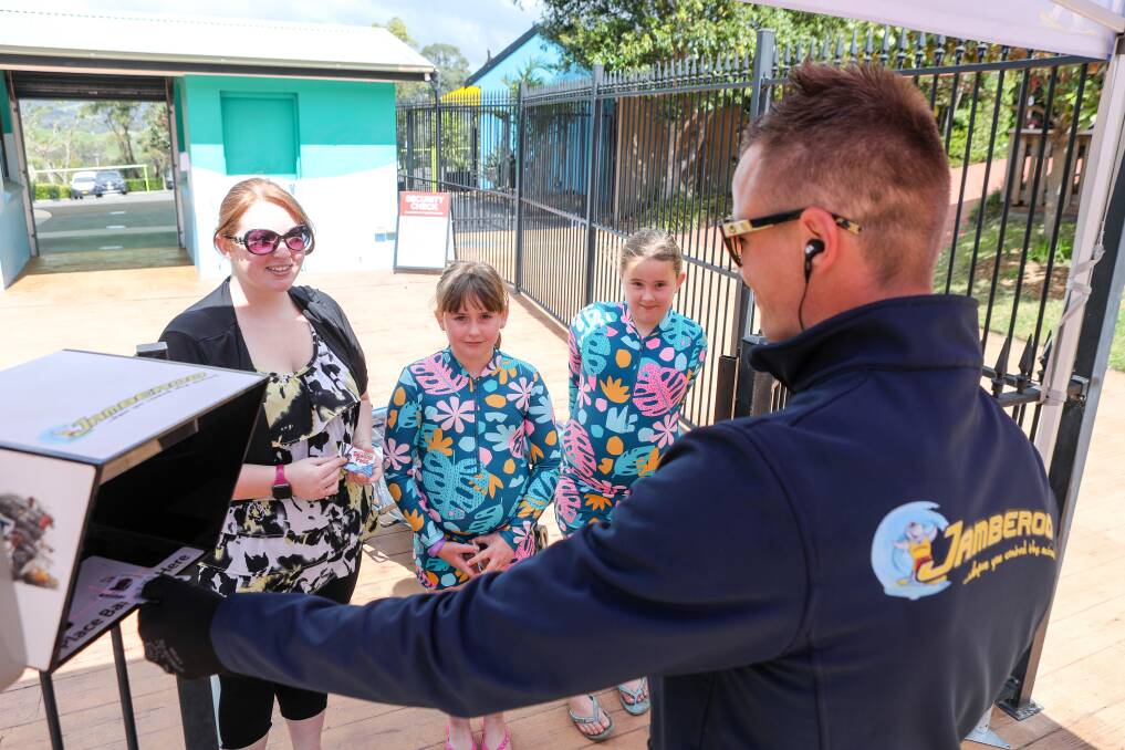 Holiday fun: Jamberoo Action Park safety officer Tom Marsh greets Josephine Browne and her daughters Claire and Amelia Browne during the season opening weekend.