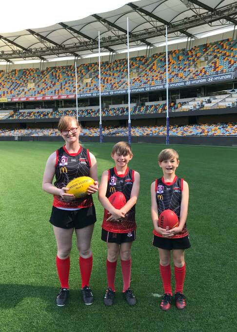 Little stars: Milan Wellington, Ryden Clarke and Hamish Carr on the ground at the Gabba. They starred in the bid to get the game to Brisbane.