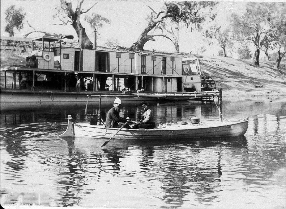 Rowing small boat on the Darling River in front of paddle steamer at Louth in 1895. Picture: Courtesy of the State Library of NSW.