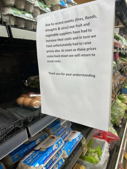 A sign put up at an IGA about fruit and vegetable prices.