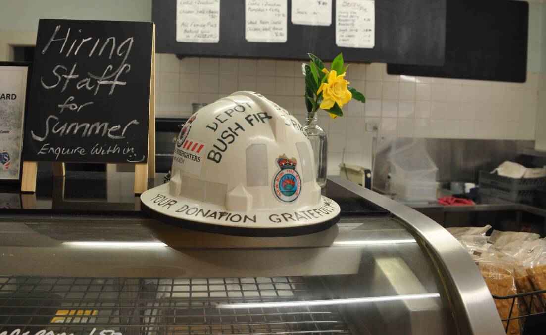 A Depot Rural Fire Bridge donation hat sitting on top of an empty pie warmer. 