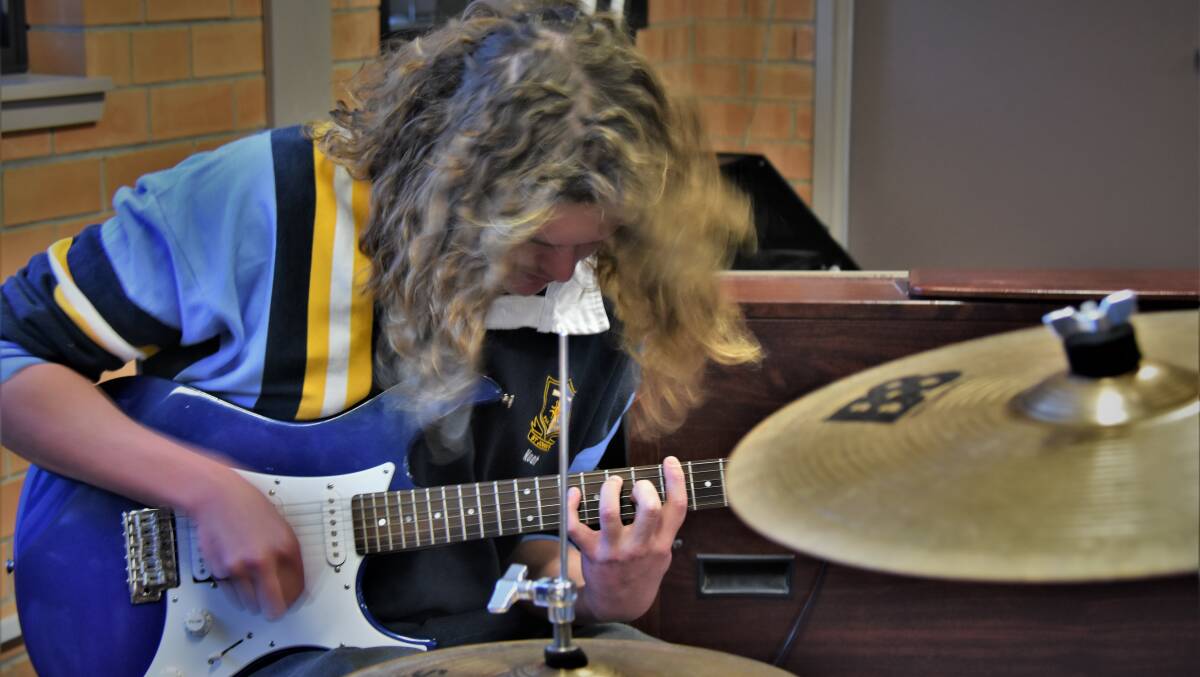 JAMMING: Debbies' Noah Egan showing off his skills on the guitar.