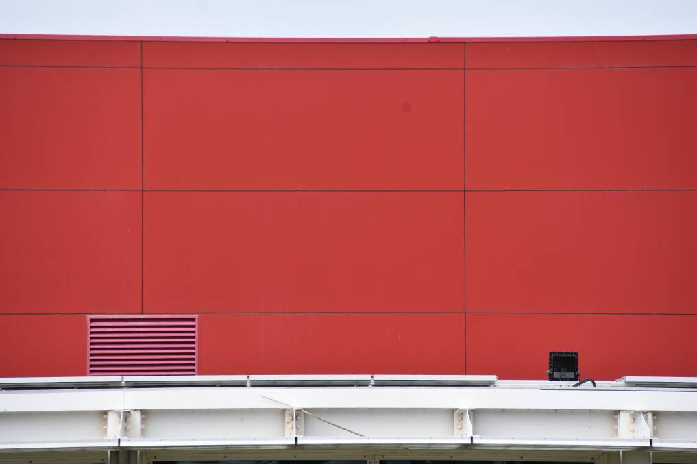 A close up of the combustible red Alucobond cladding on the Shoalhaven Entertainment Centre which is about to be removed. 