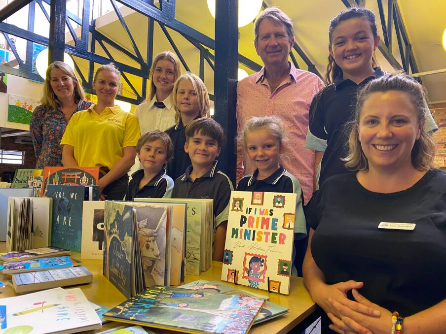BEQUEST: Bill Collin's daughter-in-law Johanna Wilson, Emily Hall, granddaughter Bree Wilson, son Graeme Wilson, teacher librarian Lucy Robertson and school kids Will Morton, Koopa Hampshere, Beau Sheppeard, Sophie Higgins and Tori-May Martin with the donated books. 