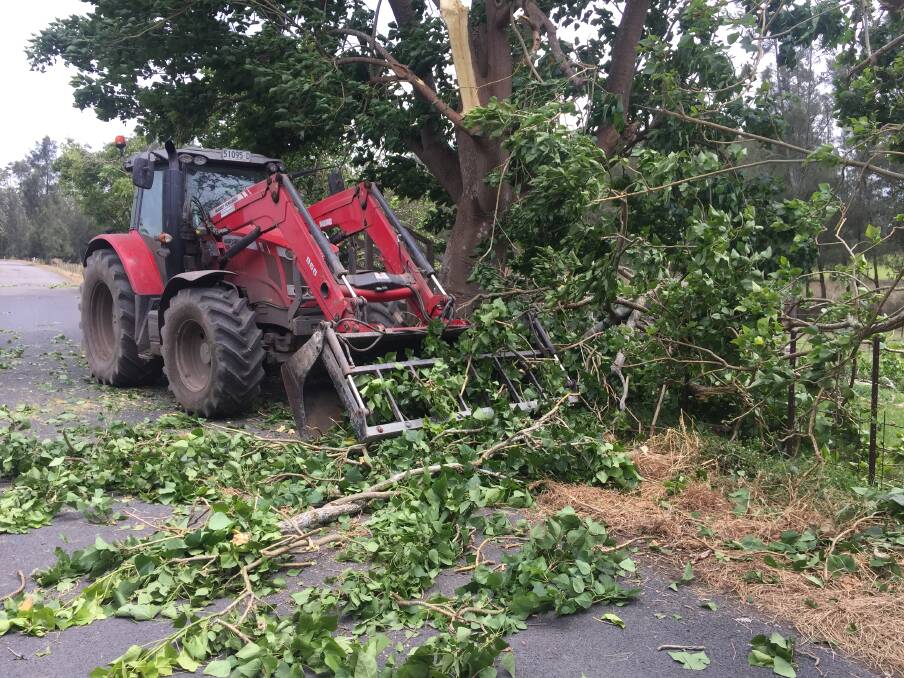A tractor works to clear a tree in Mayfield Road on Sunday afternoon.