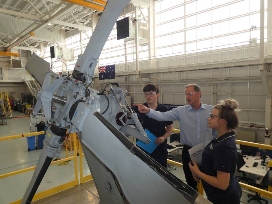 Sikorsky Australias Apprentice Aircraft Maintenance Engineer Students, Corey Plummer (left) and Nicola Douet (right) together with Aviation Training Instructor, Tony Intihar (centre), conduct maintenance checks as part of aircraft maintenance training at Sikorsky Australia. Photo: supplied.