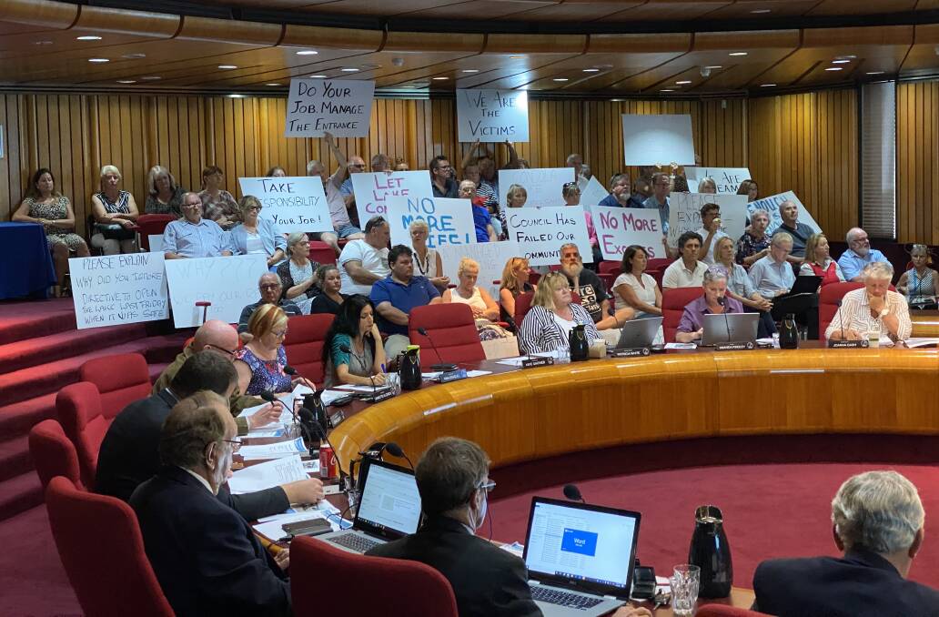 FIGHT: Protesters angry at the handling of Lake Conjola entrance filled the Shoalhaven Administrative Centre public gallery on Tuesday night.