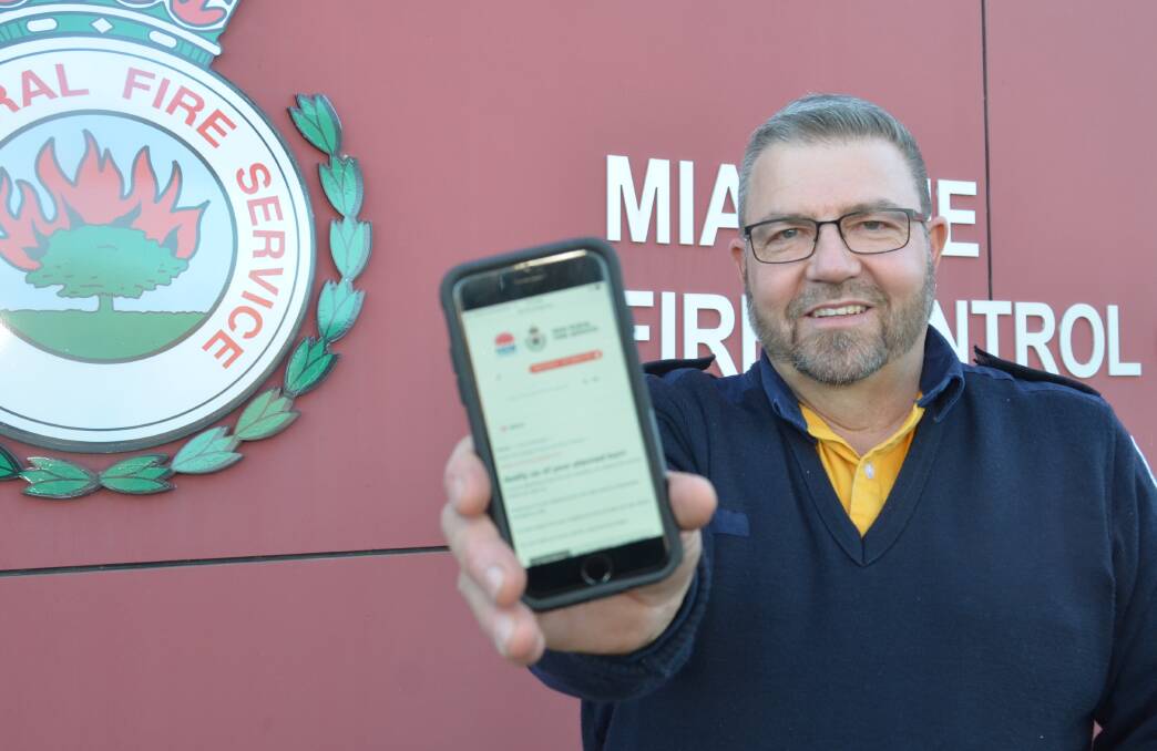 HAND HELD: The NSW RFS MIA District Inspector Jason Wall with the new online tool used to notify the RFS of planned burn offs. PHOTO: Declan Rurenga