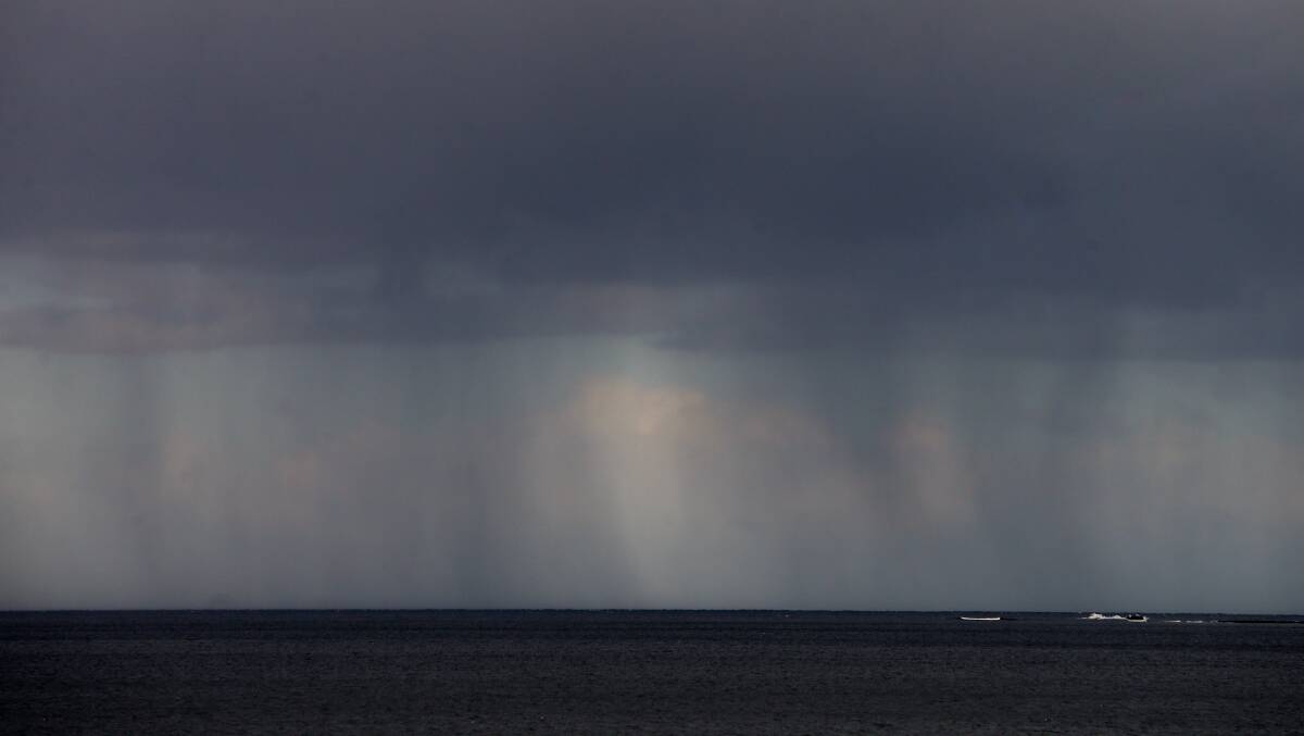 Dark clouds and rain off the Illawarra coastline. Picture by Sylvia Liber 