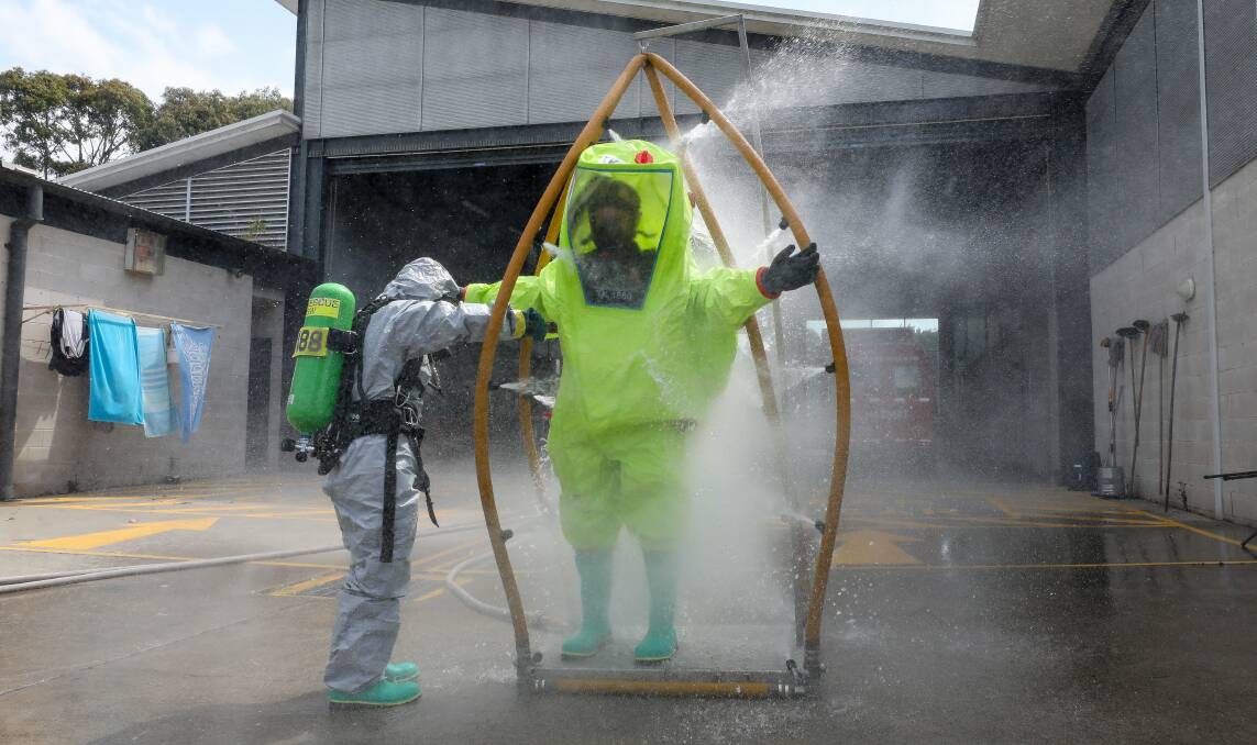 A firefighter being decontaminated at Shellharbour Fire Station. Pictures by Adam McLean
