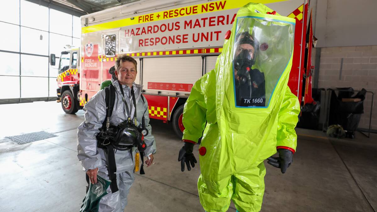 Shellharbour firefighters Vanessa McKellar and Simon Barritt in specialised suits they wear during toxic incidents call outs. Picture by Adam McLean