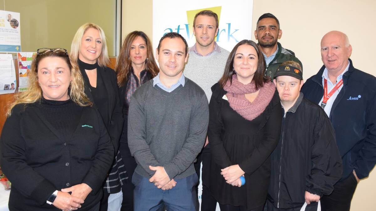 Shaun Pianta (back in grey jumper) at the Nowra atWork office with other guests and staff.