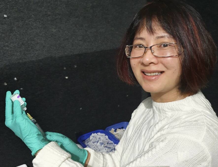  Dr Jessie Hoang gets another vaccine jab ready.