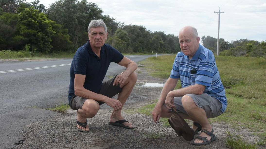 Currarong Community Association members Tony Lund and Les Lawrenson near the dangerous Currarong Road.