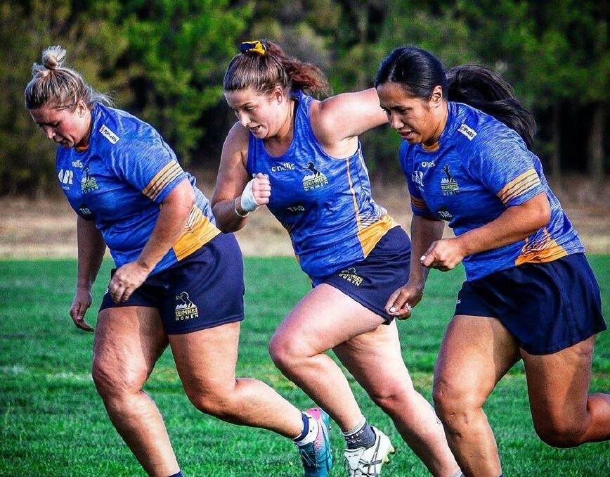 Harriet Elleman (middle) does the hard yards at training.