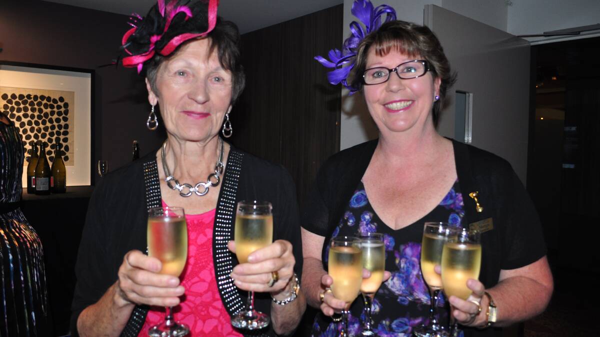 HERE CHEERS: Volunteer Nora Cunningham and Sharyn Duncan (Bomaderry Bowling Club) make sure people have something to toast their winners.