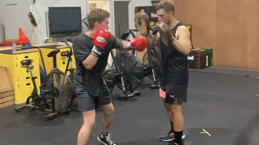  Finn Conolan [red gloves] prepares for the upcoming fight night.