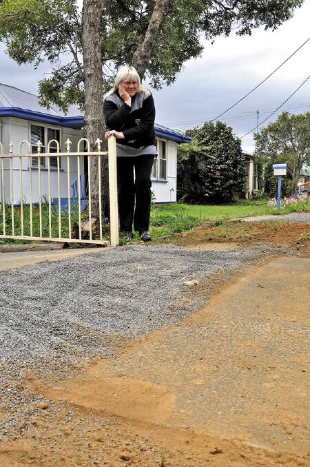 CUT UP: Ritchie Street resident Angela Marchant wants action to fix the damage to properties in her street.