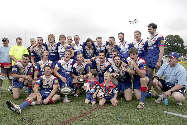 PREMIERS: The Gerringong Lions celebrate yesterday’s thrilling one-point grand final win over Warilla.