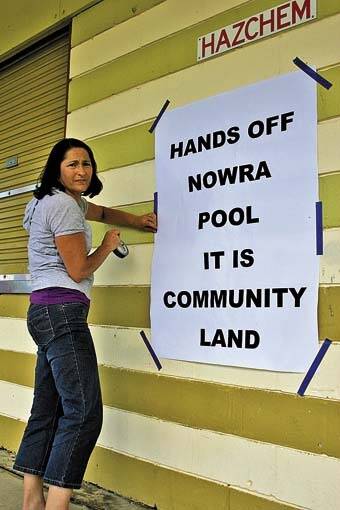 BLITZ: Head of the Save Nowra Community Pool working group Fiona Phillips, sticking up one of her campaign posters outside the Nowra pool.