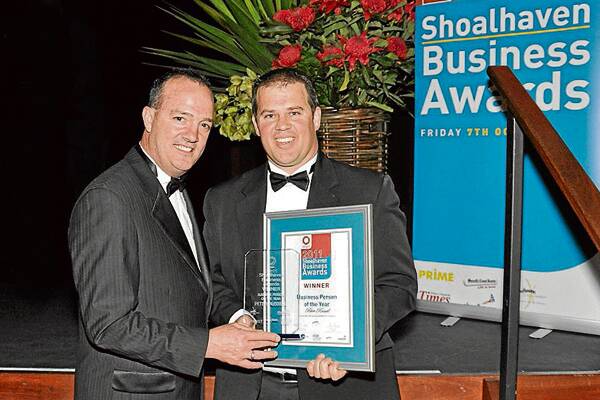 WELL DESERVED: Shoalhaven Mayor Paul Green presents Peter Russell from Integrity Real Estate with his Business Person of the Year award.