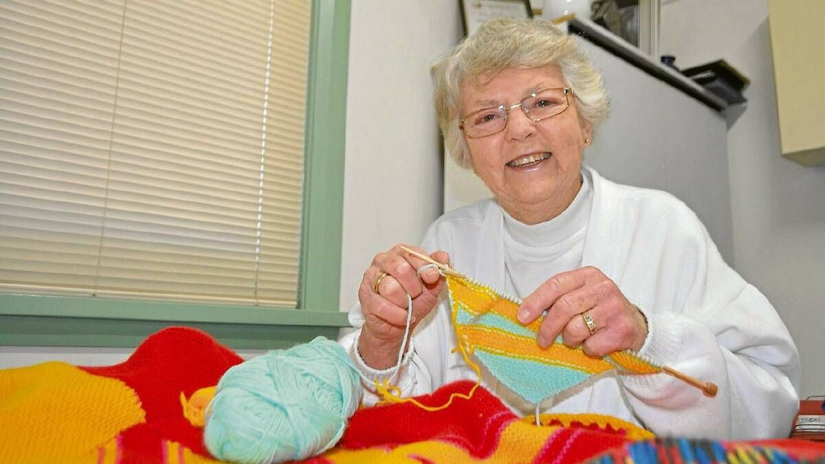 LOTS OF LOVE: Nowra Wrap with Love group co-ordinator Rae Watson working on another warm creation.